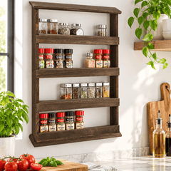 Wall mounted wooden spice rack with four tiers holding spice jars and shakers above a kitchen bench with tomatoes and basil