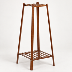 Empty brown bamboo plant stand in angled view showing slatted top and bottom shelves and screw joints