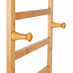 Close-up of two round wooden side hooks on the bamboo clothes rack frame