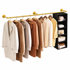 Gold wall mounted pipe clothes rack with coats and sweaters on hangers and a black hanging shelf organizer at one end