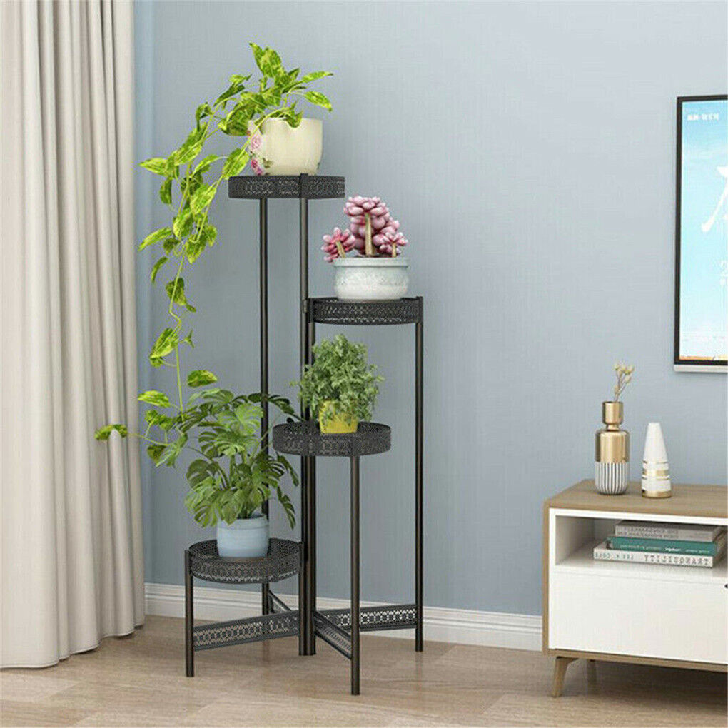 Black metal plant stand expanded in a room corner