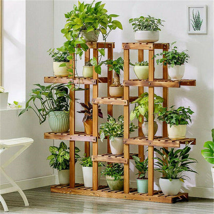 Wide wooden plant stand filled with assorted pots