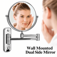 Woman looking at her face in a round double sided wall mounted mirror with a chrome extendable arm